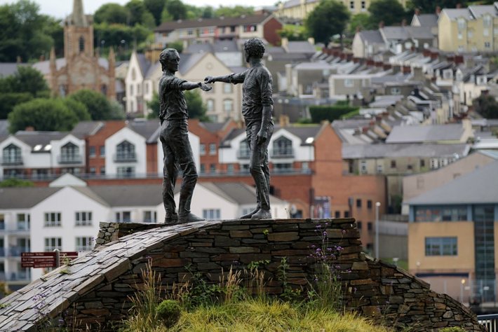 Hands Across the Divide, a sculpture in Derry, Northern Ireland,  created by Maurice Harron, and erected in 1992, stands on the western side of the Craigavon Bridge and symbolizes reconciliation between both sides of the political divide during The Troubles.